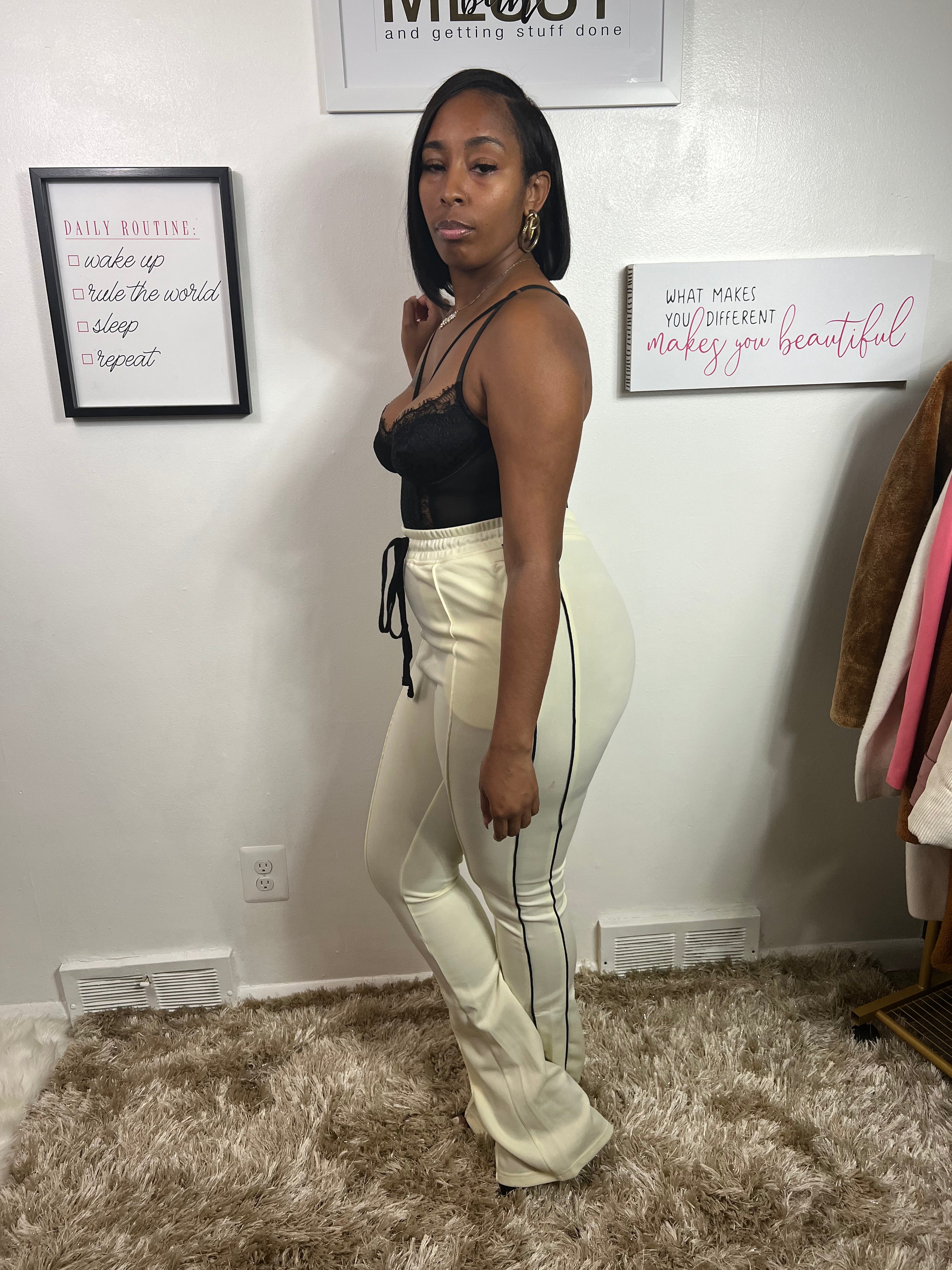 Beautiful pants that are flared sweatpants track-suit colored, slightly yellow/beige color, drawstrings and side stripes, and an elastic waistband with drawstring, .